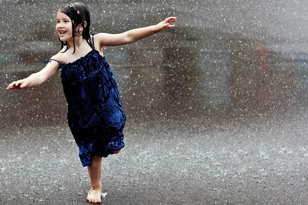 A girl in a blue dress in the rain