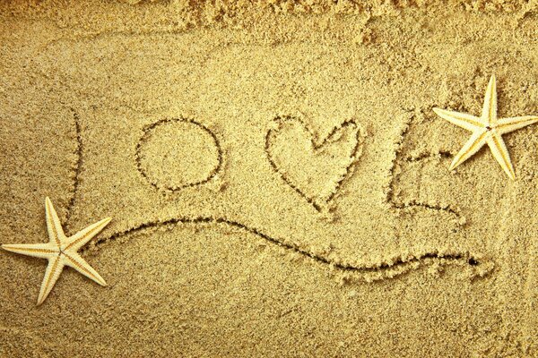 Obraz słowa miłości i gwiazd na piasku