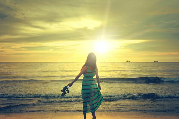 La chica admira la ola del mar y el cielo