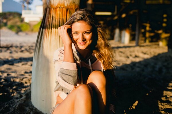 Smiling girl on the beach in the sun