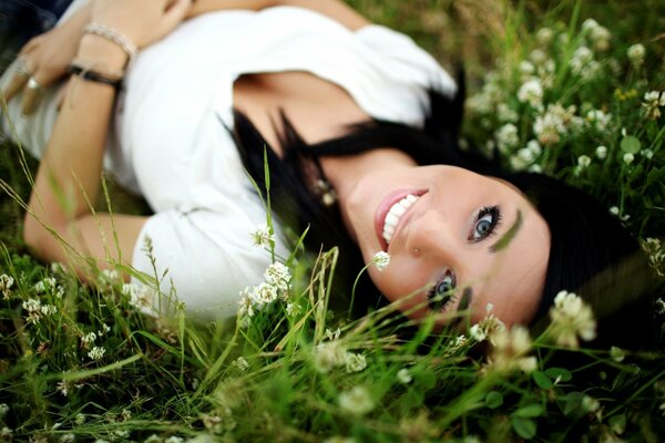 Smiling brunette on a green meadow