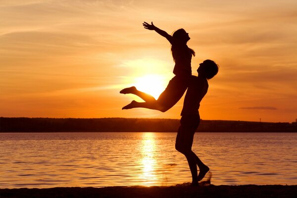 A couple on the background of sunset. Love and romance