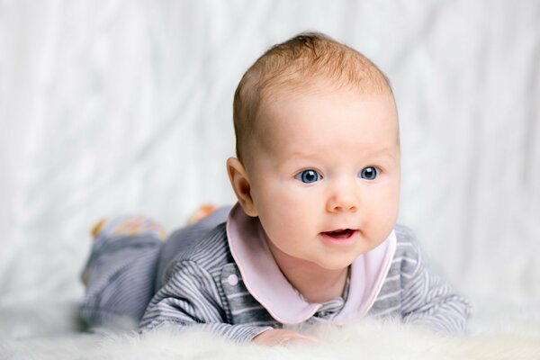 Piccolo bambino sdraiato su un letto di piume