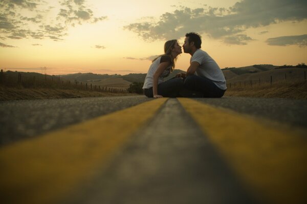 A couple in love kissing on the road