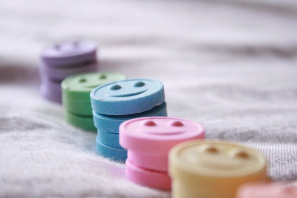Colorful candies with a smile on the tablecloth