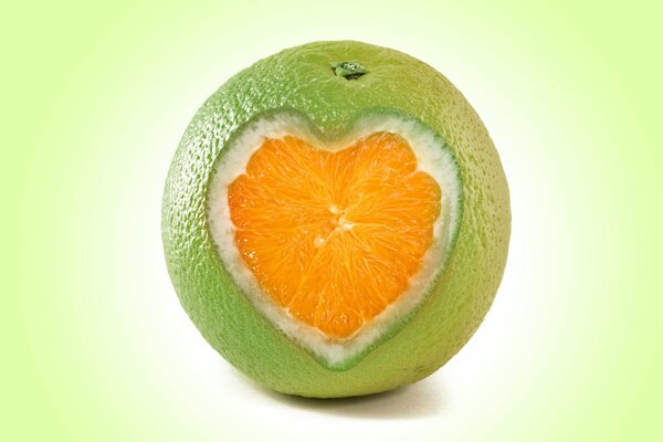 A green orange with an orange heart-shaped core