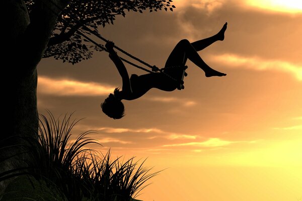 A girl at sunset rides on a swing over a precipice