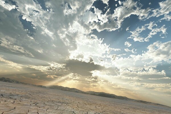 The sun s rays break through the cloudy sky