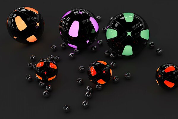 Multicolored spheres lie on a black table