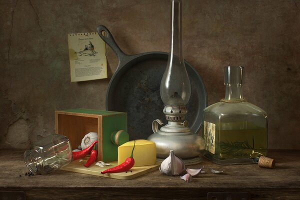 Still life with pepper, frying pan and olive lamp