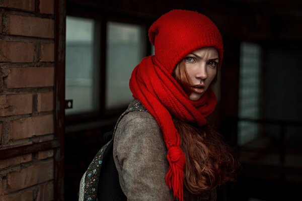 Angry girl in a hat with a scarf