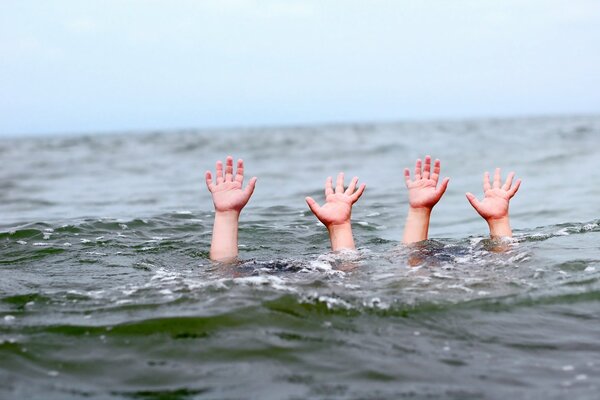 Hands above the water of drowning