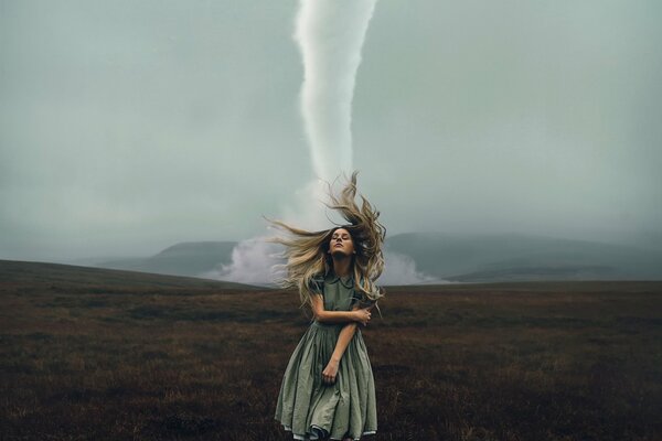 Tornado girl standing in a field