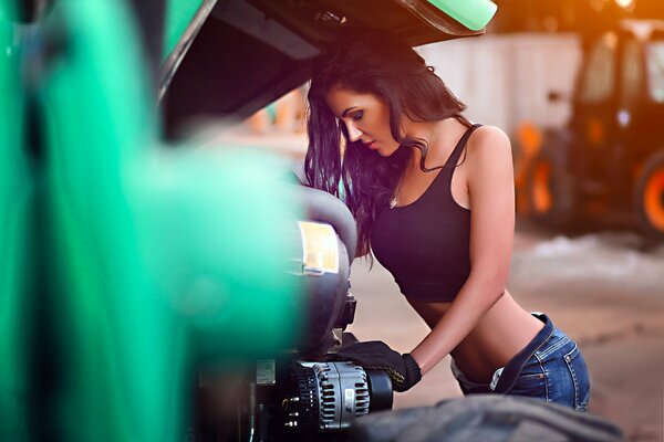 Brunette girl picks at the engine