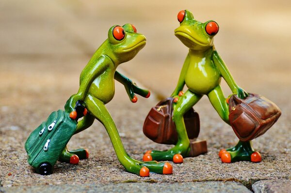 Frog figurines with suitcases