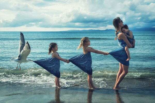 Mom and daughters on the coast