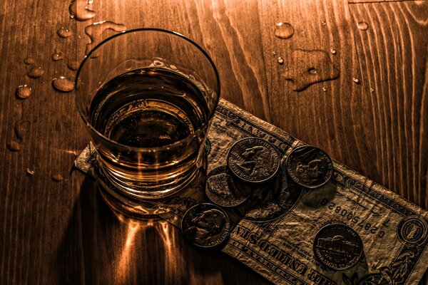 A table with a stack of alcohol coins and a dollar