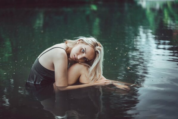 Beautiful girl in a cold lake