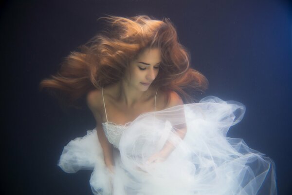 Red-haired girl in a wedding dress