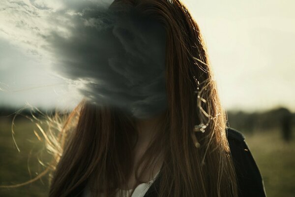 A cloud instead of a face. Girl in the field