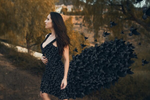 A girl in a dress made of black birds