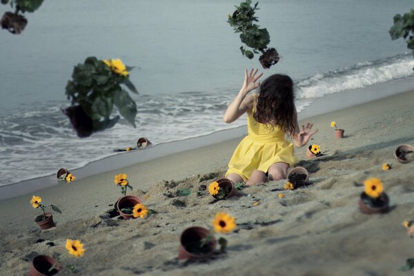 A girl in a yellow dress on the sand