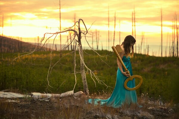 A girl with a big key in the forest