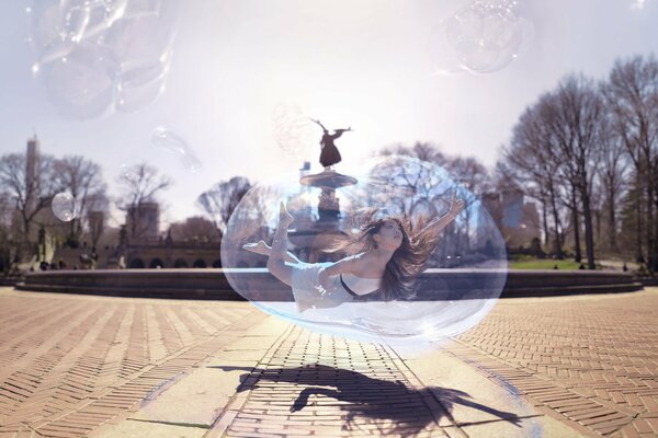 The girl is flying in a bubble