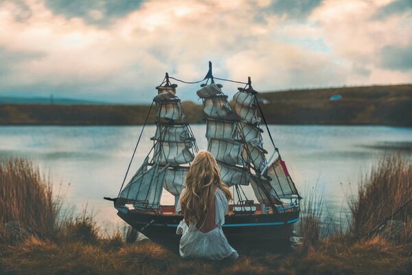 Mädchen mit Schiff am Ufer