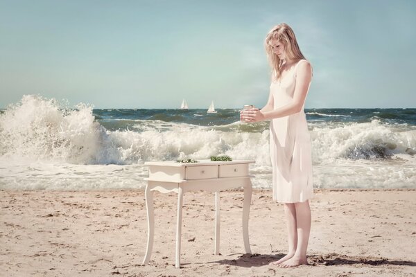 A girl in a white dress on the seashore