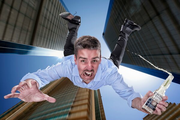 Guy tombe en bas avec une bouteille dans ses mains