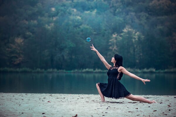 A girl on the riverbank dancing