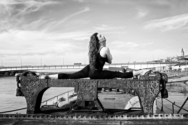 A beautiful girl is sitting on a twine