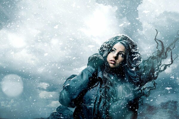 A girl walking through a heavy snowstorm