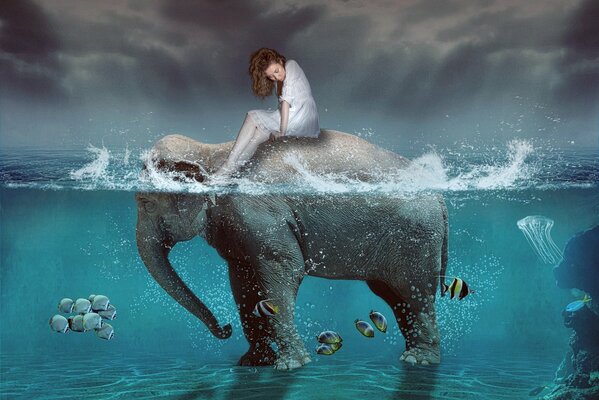 A girl sits on an elephant in the sea