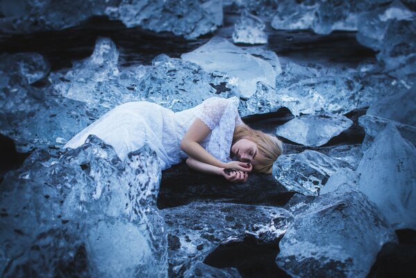 The girl is lying in the ice