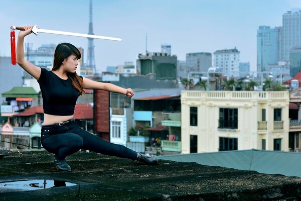 Fille asiatique avec une épée sur le toit