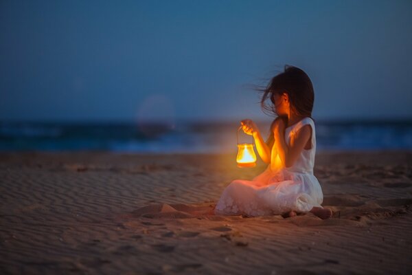 A girl on the background of the sea at dusk