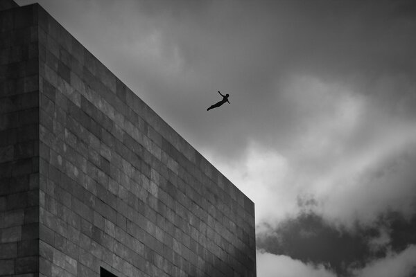 A man jumps from the roof of a building