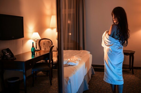 Girl by the bed lamp light