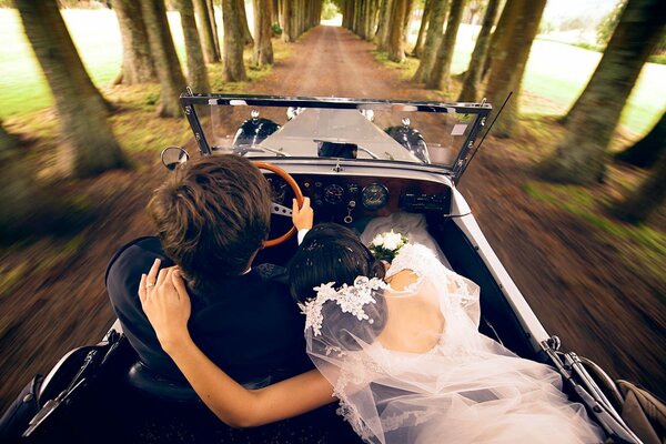 The bride and groom are traveling by car