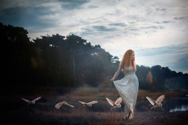 Red-haired girl in a white dress