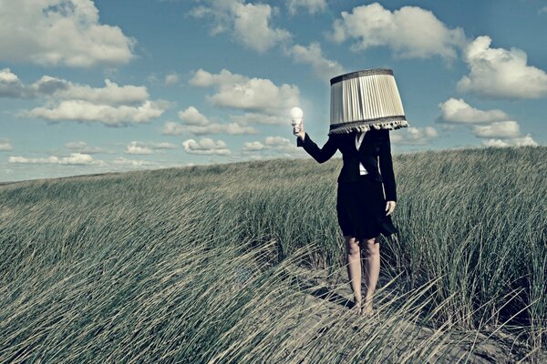 Lampshade girl with a light bulb in her hand