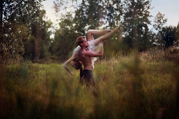 Guy with a girl dancing in nature