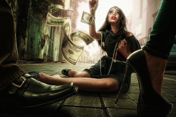 A girl on the ground. Money. Bills are flying