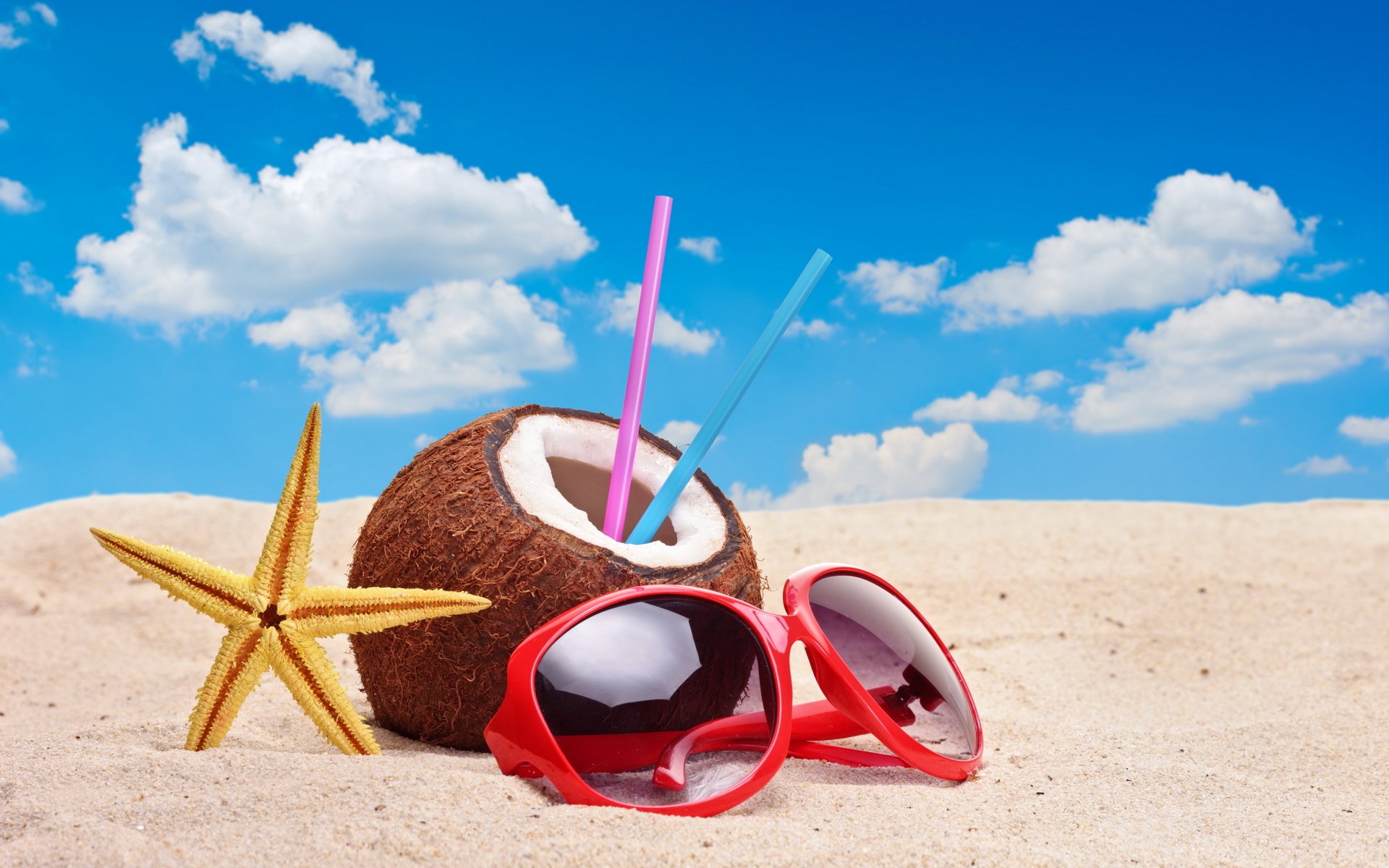 beach sand coconut red sunglasses starfish tube straw sky cloud