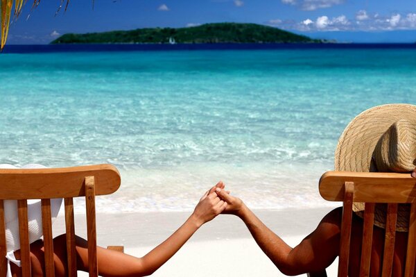 Couple at sea holding hands