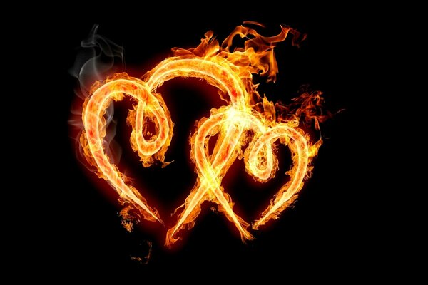 Dos corazones de fuego ardiendo en la oscuridad