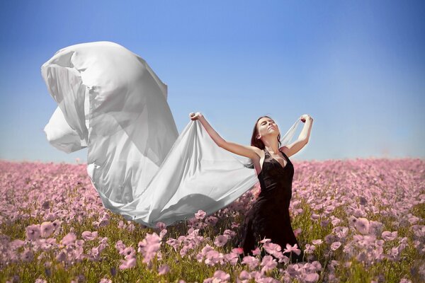 A girl in a field of pink flowers