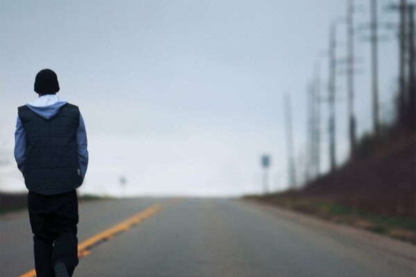 A guy walking down the road alone